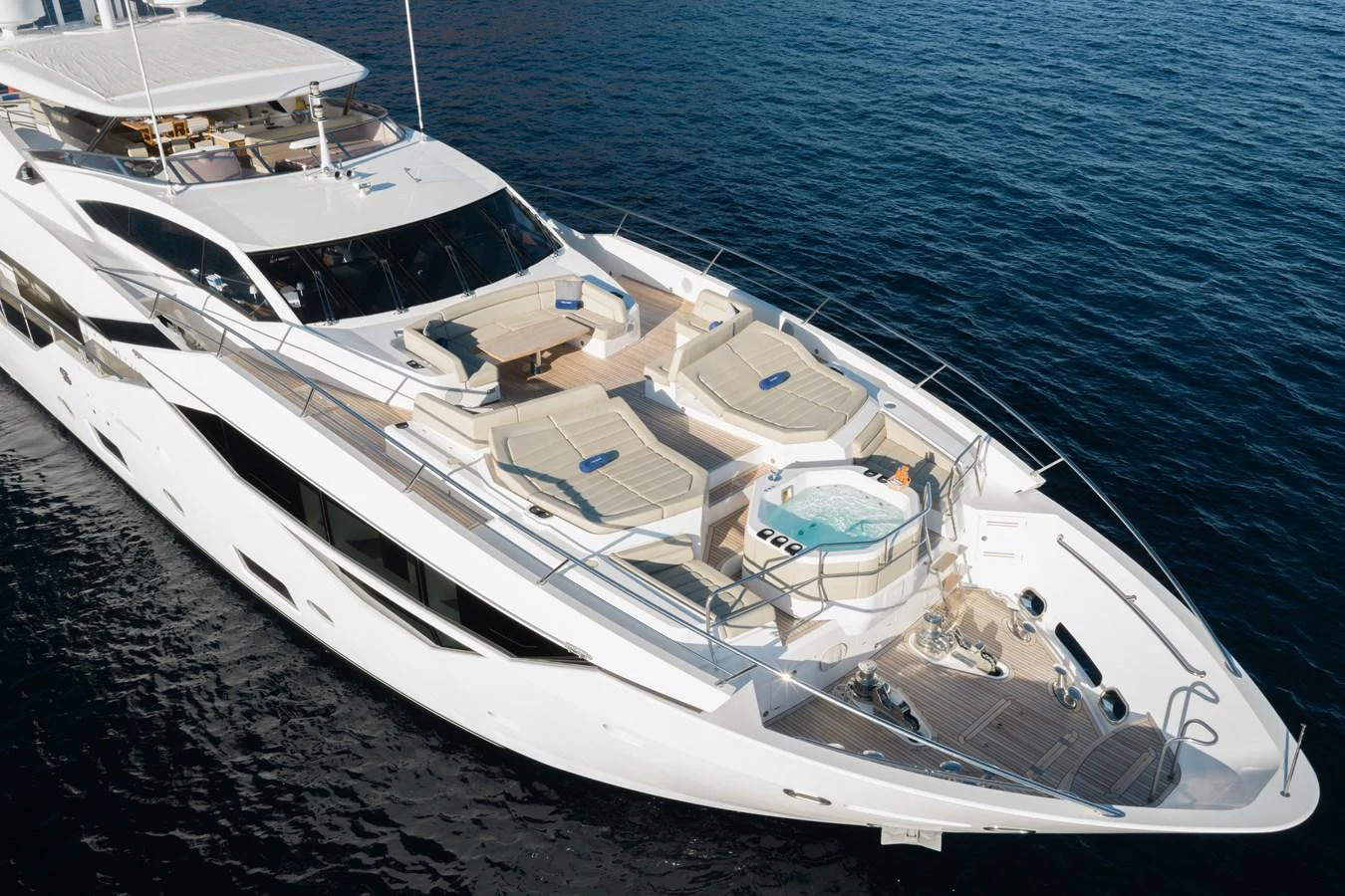 The yacht's foredeck features luxurious sun loungers and a jacuzzi, perfect for relaxation. aboard KING POWER Yacht for Sale