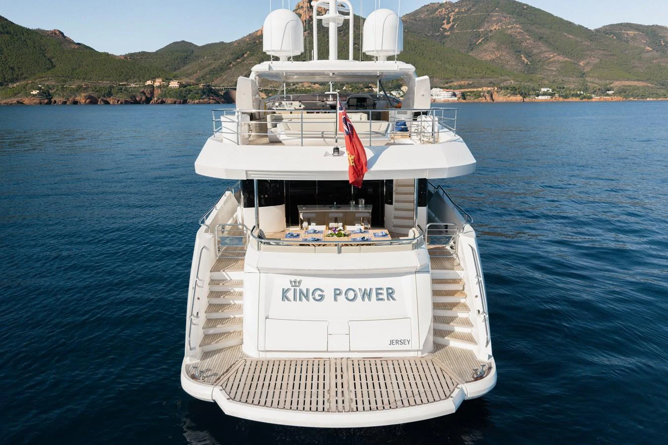 The yacht's aft deck offers a luxurious space with elegant dining setup and easy access to the water. aboard KING POWER Yacht for Sale