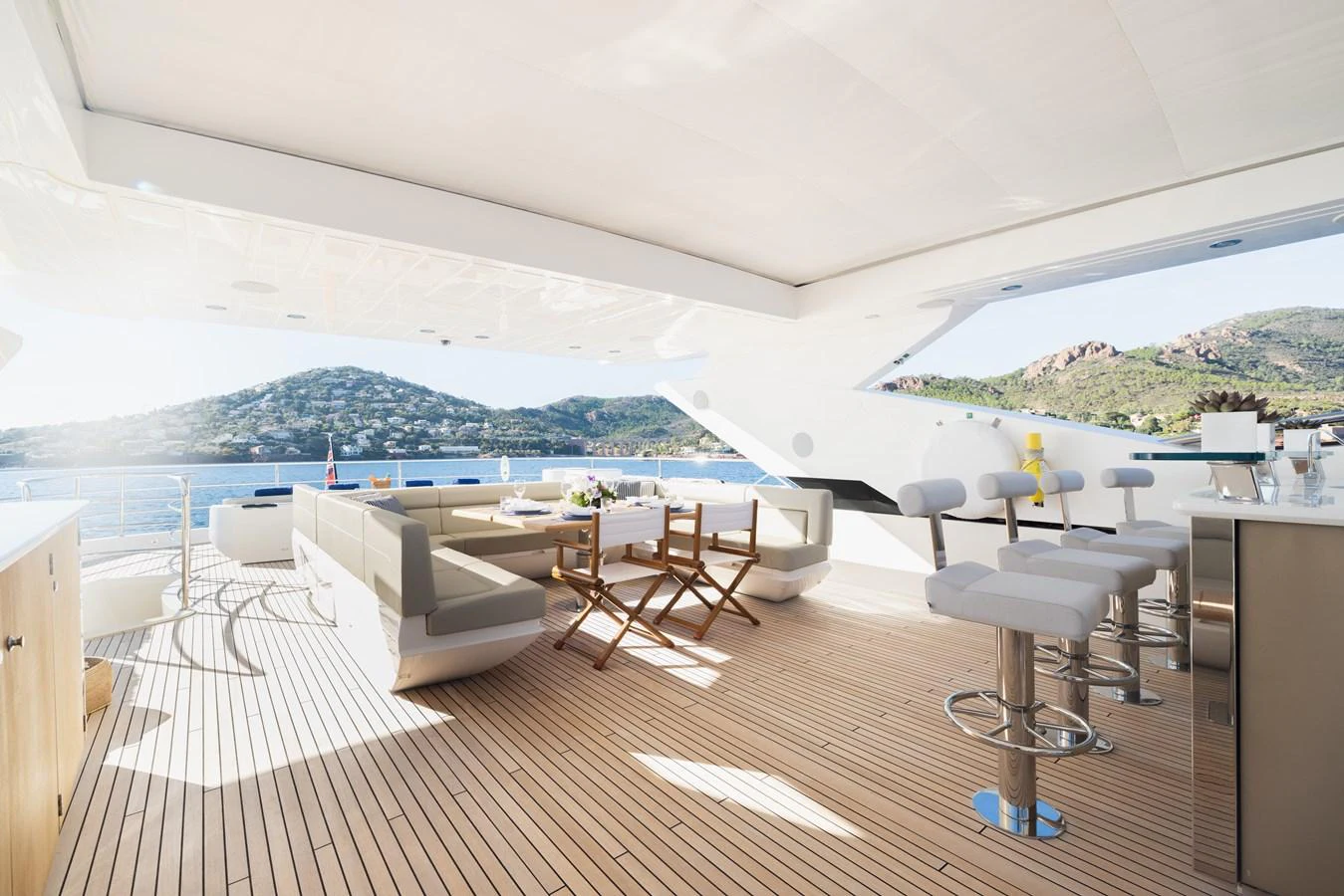 The aft deck offers a spacious and luxurious outdoor seating area with stunning views. aboard KING POWER Yacht for Sale