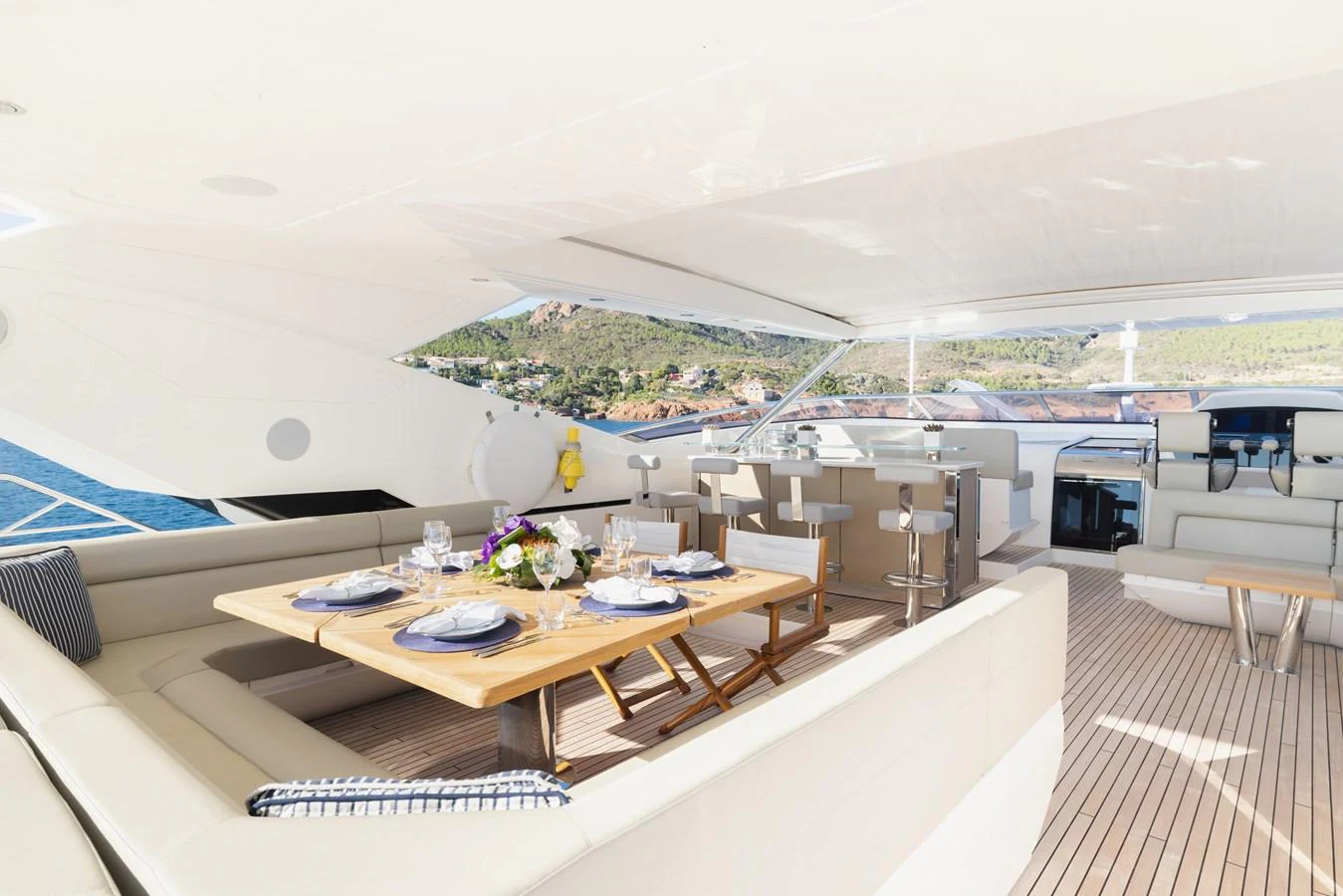 The aft deck features an elegant dining area with a stunning view of the surrounding waters. aboard KING POWER Yacht for Sale