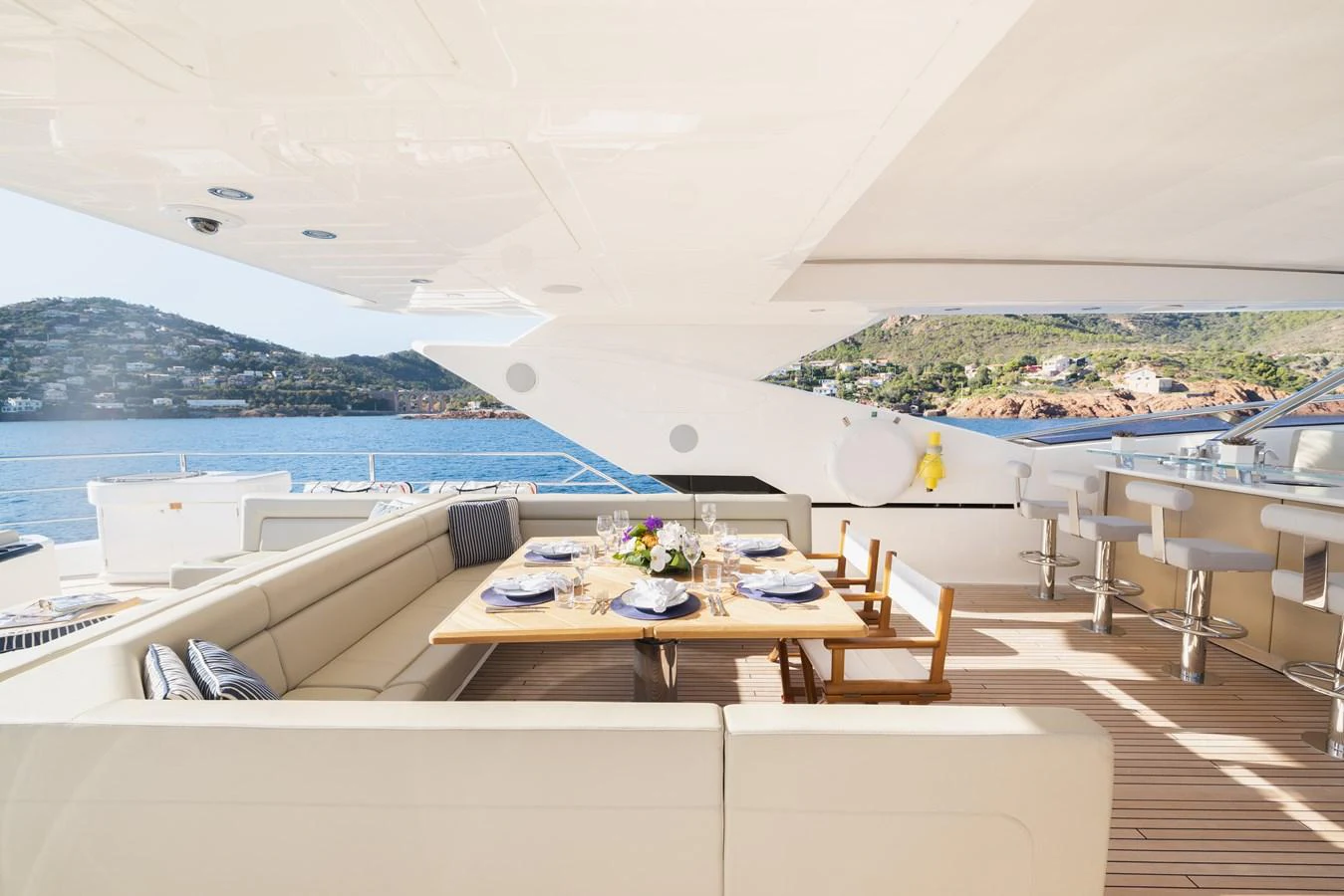 The aft deck features a spacious dining area with a beautiful ocean view. aboard KING POWER Yacht for Sale