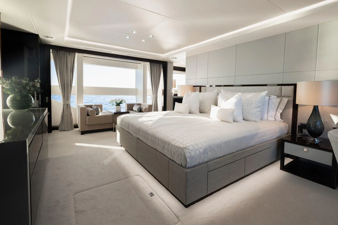 The master stateroom features a spacious layout with a large bed, elegant decor, and a stunning view of the sea. aboard KING POWER Yacht for Sale