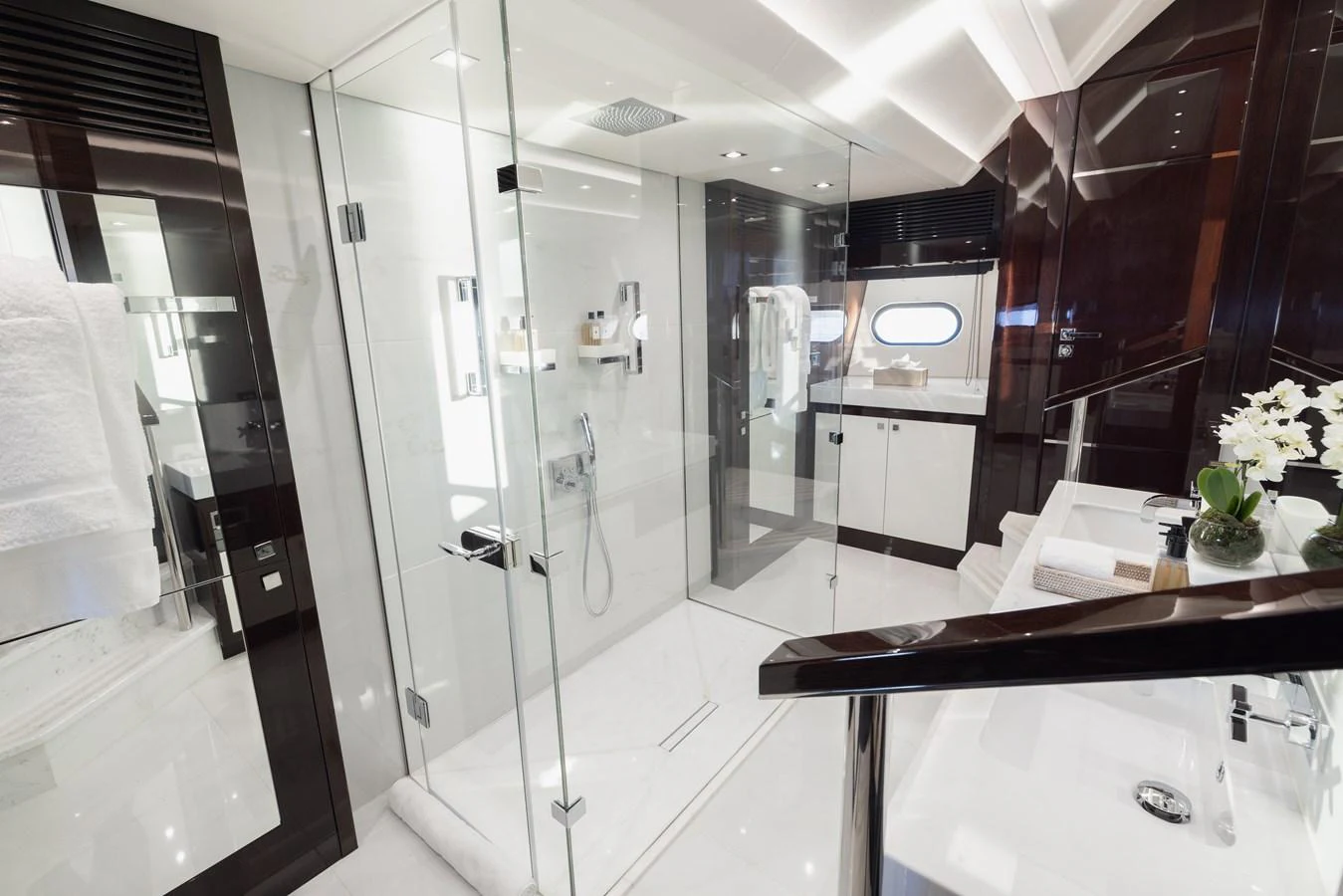 The yacht's bathroom features a sleek, modern design with glass shower enclosure and elegant fixtures. aboard KING POWER Yacht for Sale