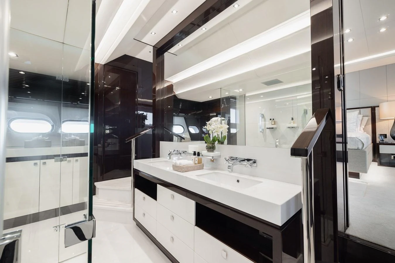 A luxurious yacht bathroom featuring a double sink vanity and modern fixtures. aboard KING POWER Yacht for Sale