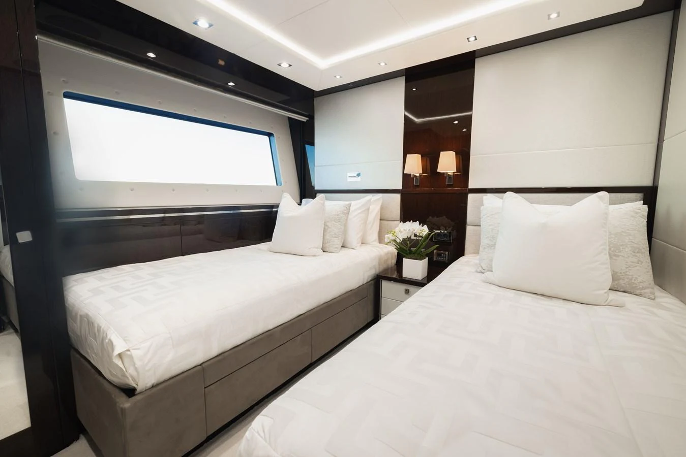 The guest stateroom features twin beds with luxurious bedding and modern lighting. aboard KING POWER Yacht for Sale