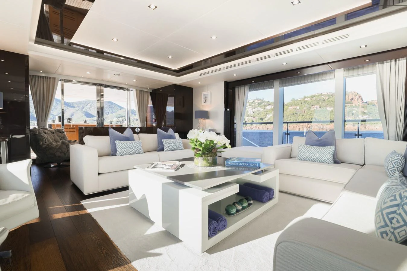 The spacious salon features elegant seating with panoramic views through large windows. aboard KING POWER Yacht for Sale