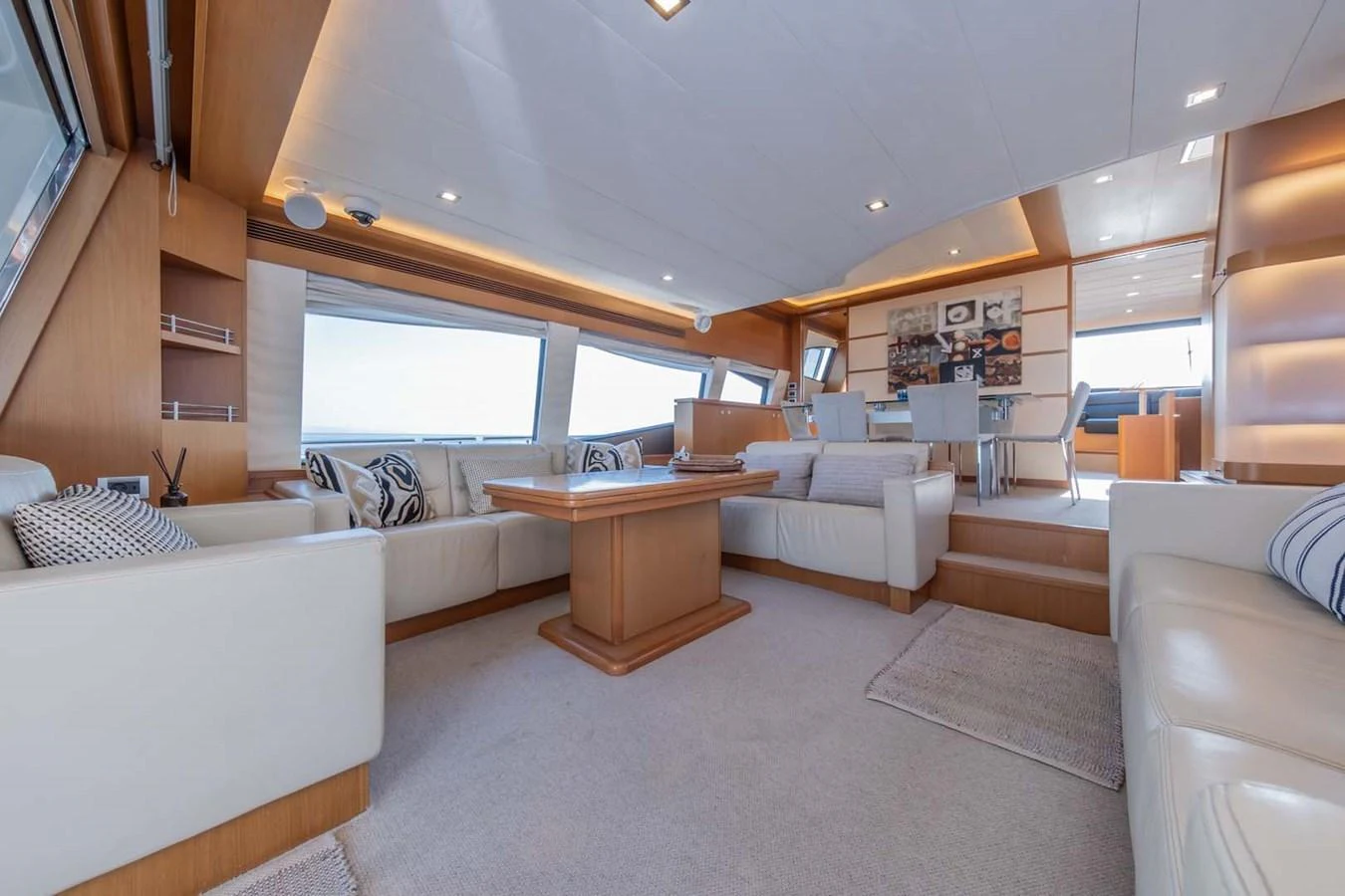 a living room with a table and couches aboard STELLINA Yacht for Sale