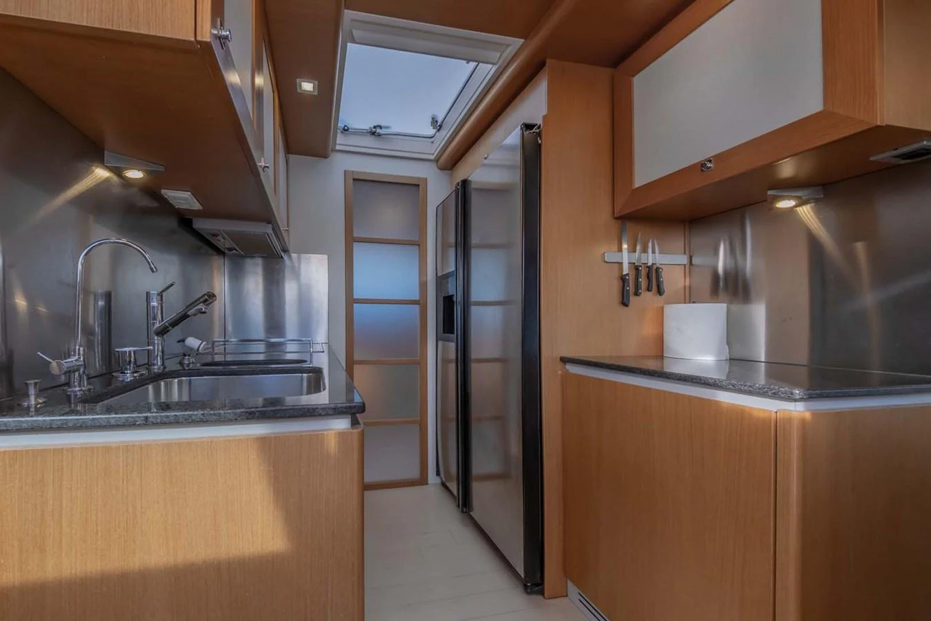 a kitchen with wooden cabinets aboard STELLINA Yacht for Sale