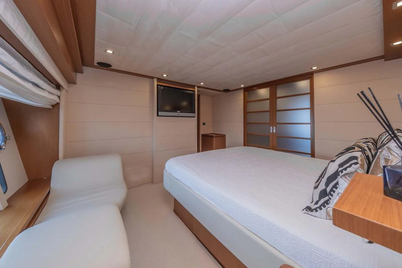 a bedroom with a bed and a television aboard STELLINA Yacht for Sale