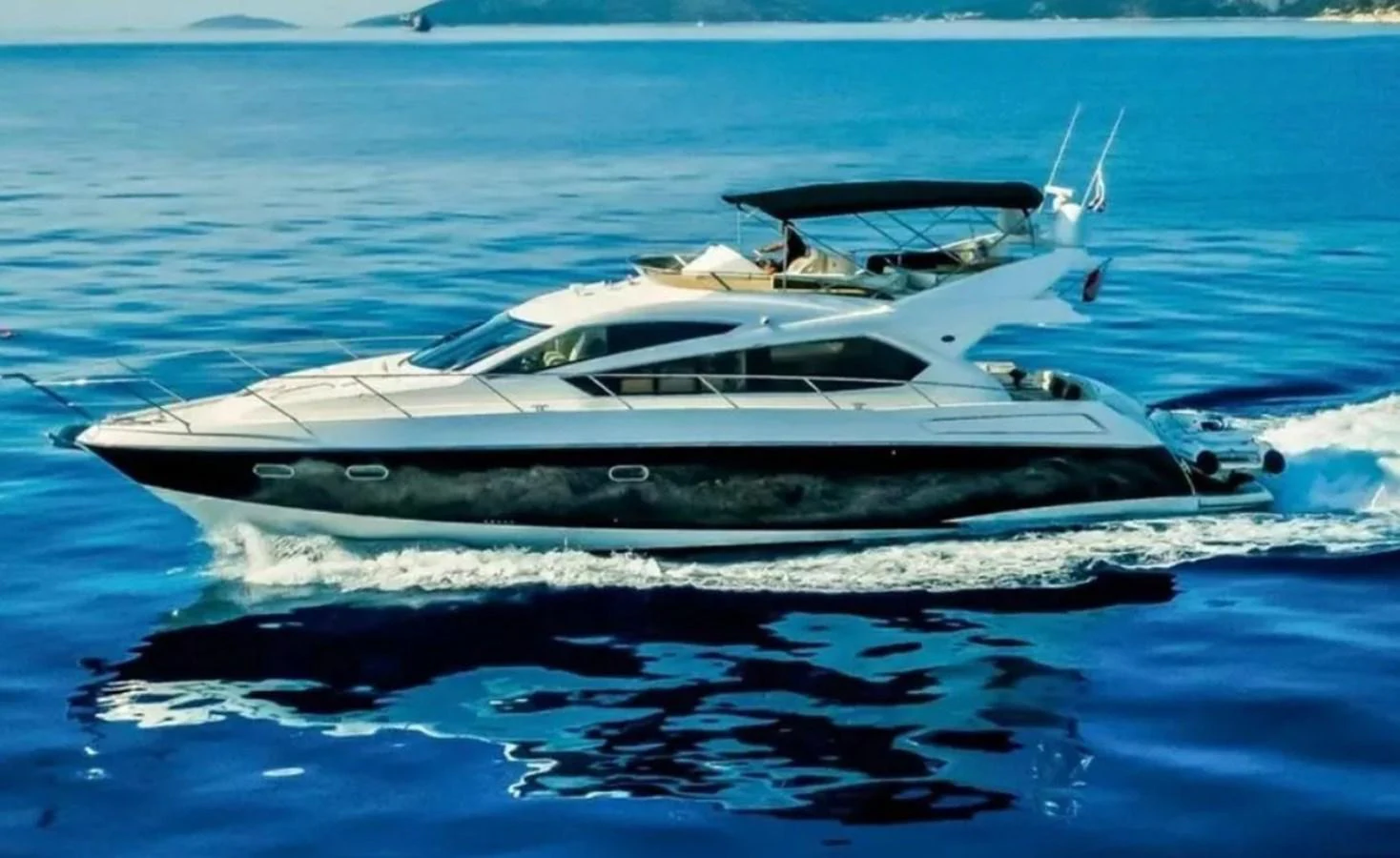 a white yacht in the water aboard 2 DRUNK Yacht for Sale