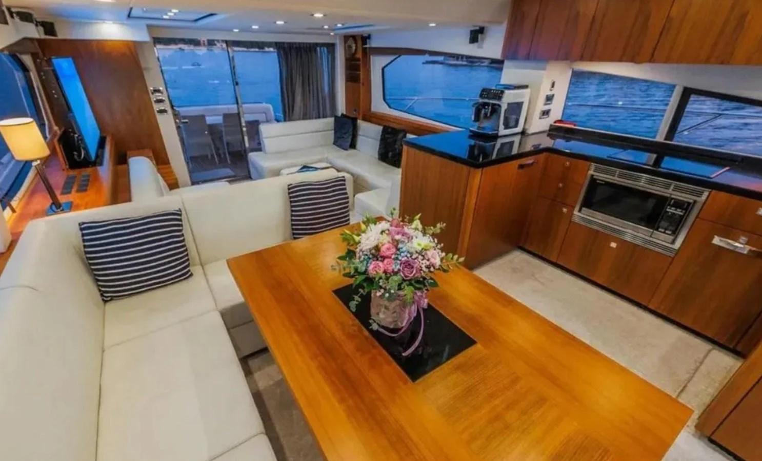 a living room with a table and couches aboard 2 DRUNK Yacht for Sale