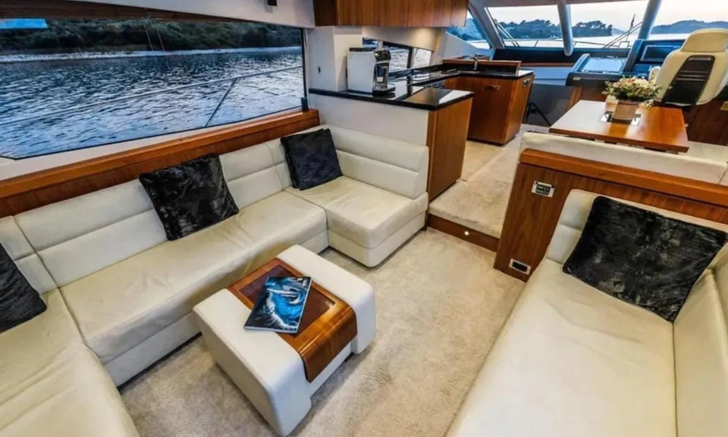 a living room with a couch and a table aboard 2 DRUNK Yacht for Sale