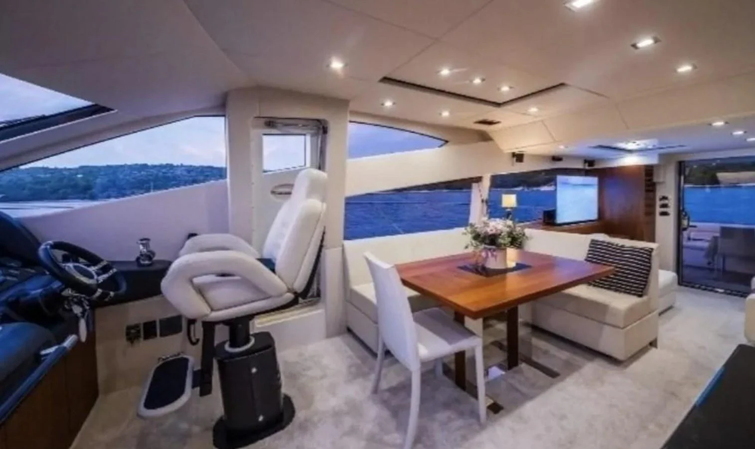 a room with a table chairs and a large window aboard 2 DRUNK Yacht for Sale