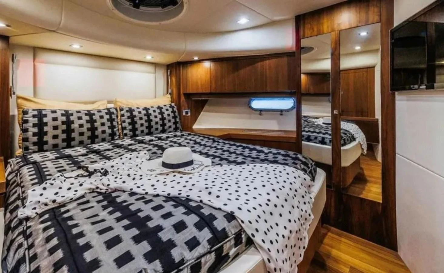 a bedroom with a bed and a mirror aboard 2 DRUNK Yacht for Sale