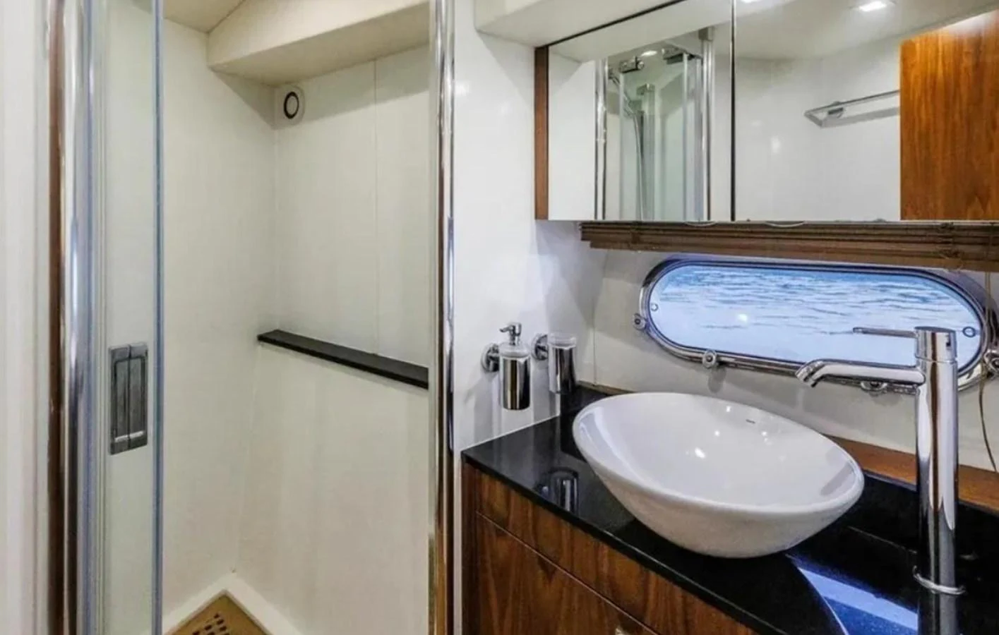 a bathroom with a sink and a large mirror aboard 2 DRUNK Yacht for Sale