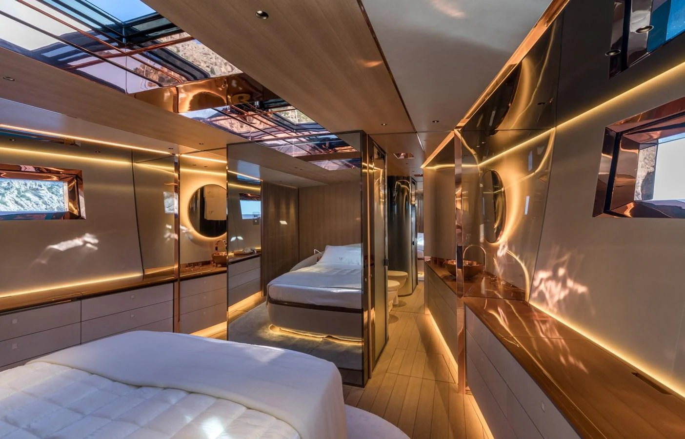 The luxurious stateroom features modern design elements with warm lighting and ample natural light from the windows. aboard ANOMALY Yacht for Sale
