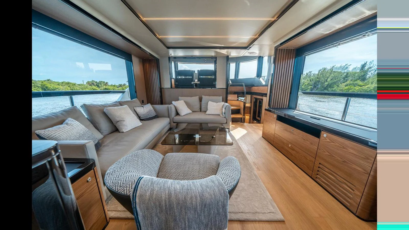 a living room with a large window aboard OUR TRADE Yacht for Sale