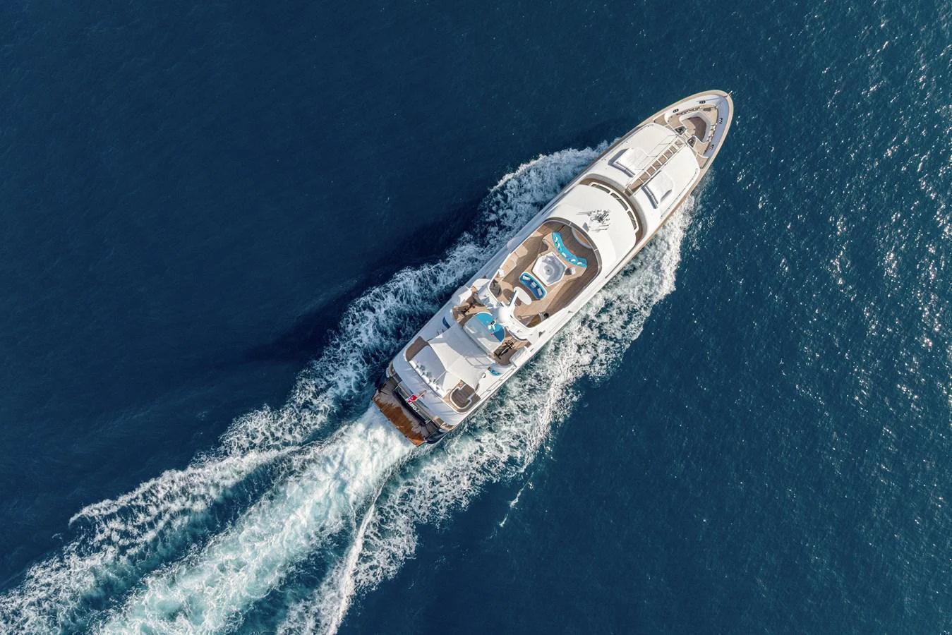 Aerial view of a luxurious yacht cruising through the open sea. aboard BANG! Yacht for Sale