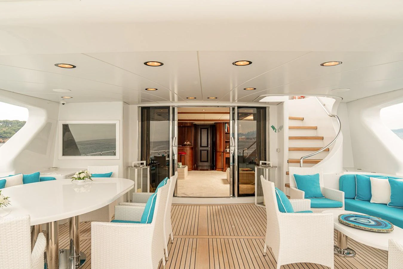 The aft deck offers a spacious and inviting area with comfortable seating and a dining table, perfect for alfresco dining and relaxation. aboard BANG! Yacht for Sale