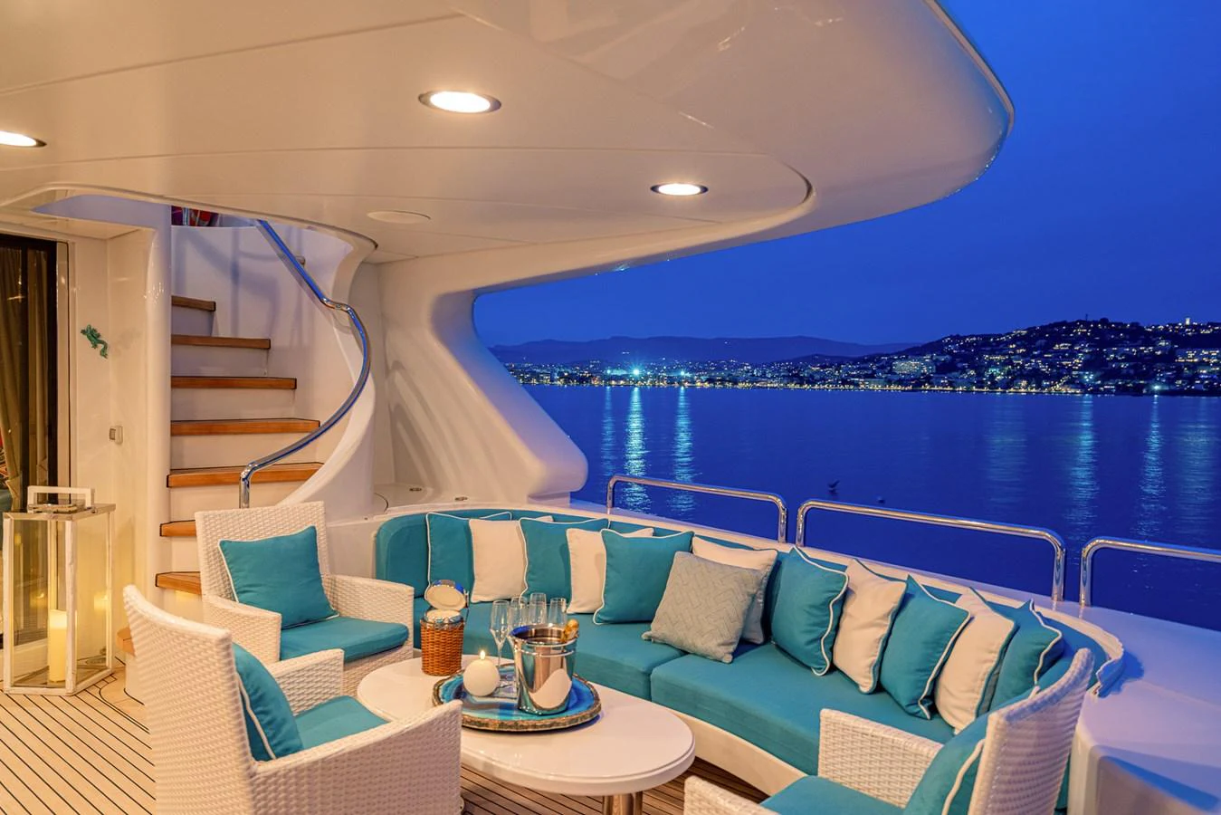 The aft deck features a cozy seating area with a stunning view of the water and city lights. aboard BANG! Yacht for Sale