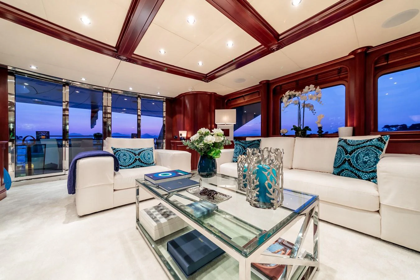 The salon features luxurious seating with elegant decor and expansive windows offering stunning views. aboard BANG! Yacht for Sale