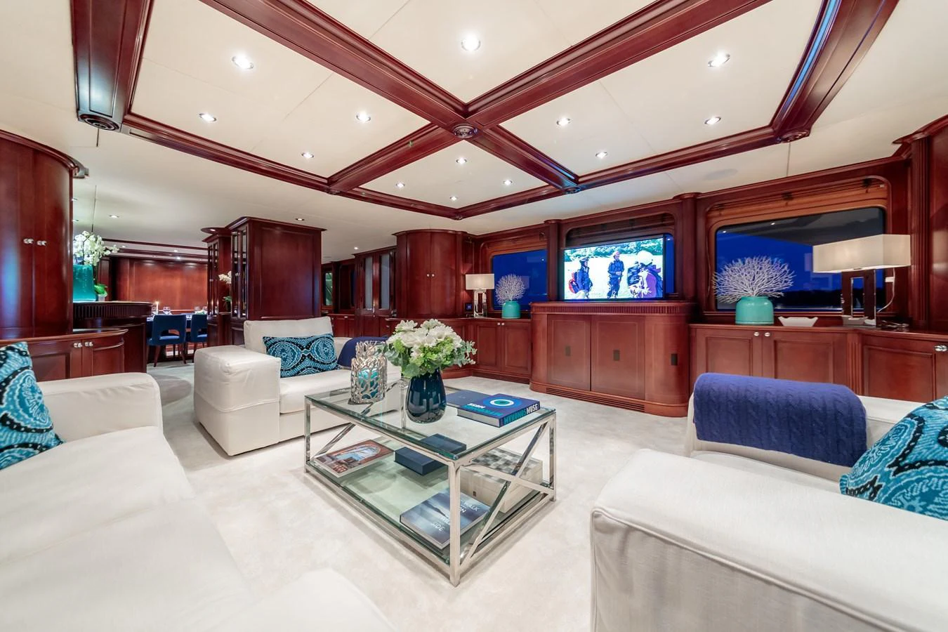The yacht's salon features elegant wood paneling, plush seating, and a sophisticated ambiance. aboard BANG! Yacht for Sale