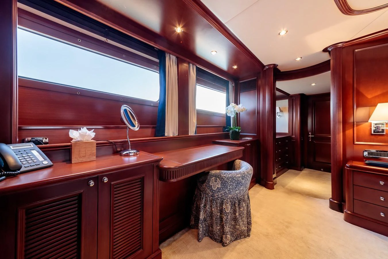 The stateroom features elegant wood paneling and luxurious furnishings, creating a warm and inviting atmosphere. aboard BANG! Yacht for Sale
