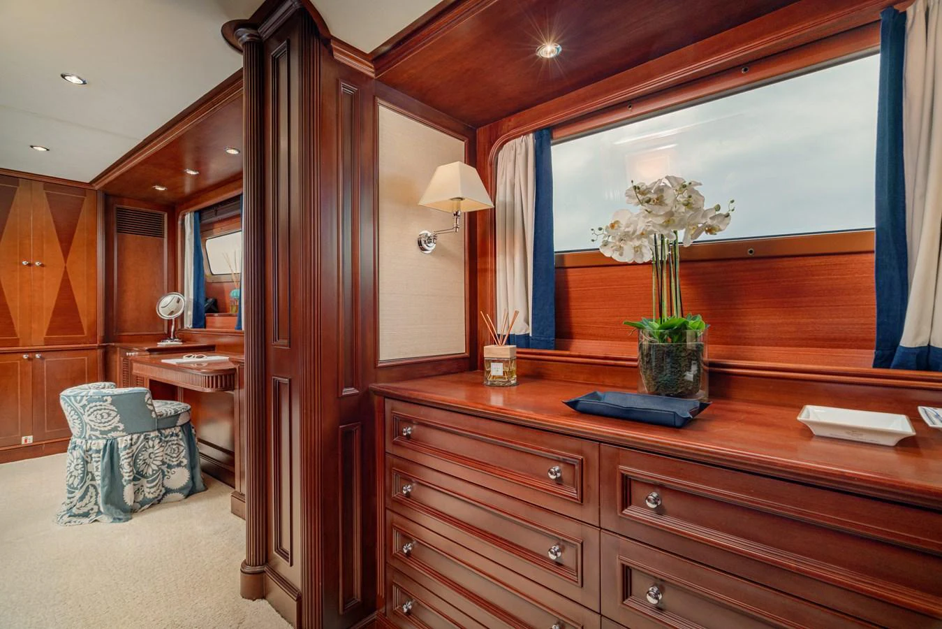 The stateroom features elegant wood paneling and luxurious furnishings, creating a warm and inviting atmosphere. aboard BANG! Yacht for Sale