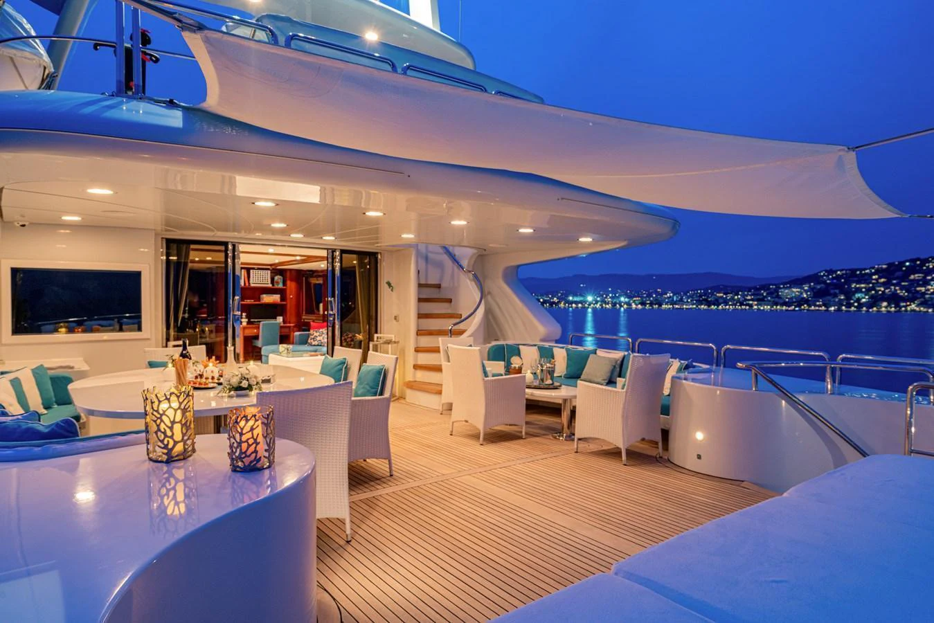 The aft deck offers an inviting space with elegant seating and ambient lighting, perfect for evening relaxation. aboard BANG! Yacht for Sale