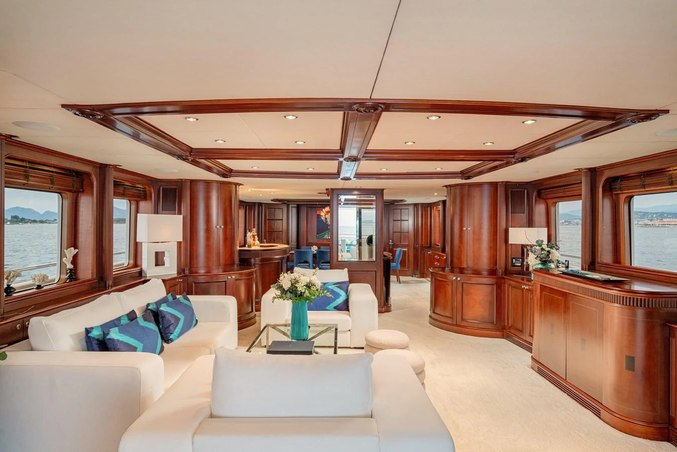 The yacht's salon features elegant woodwork, plush seating, and expansive windows offering stunning views. aboard BANG! Yacht for Sale
