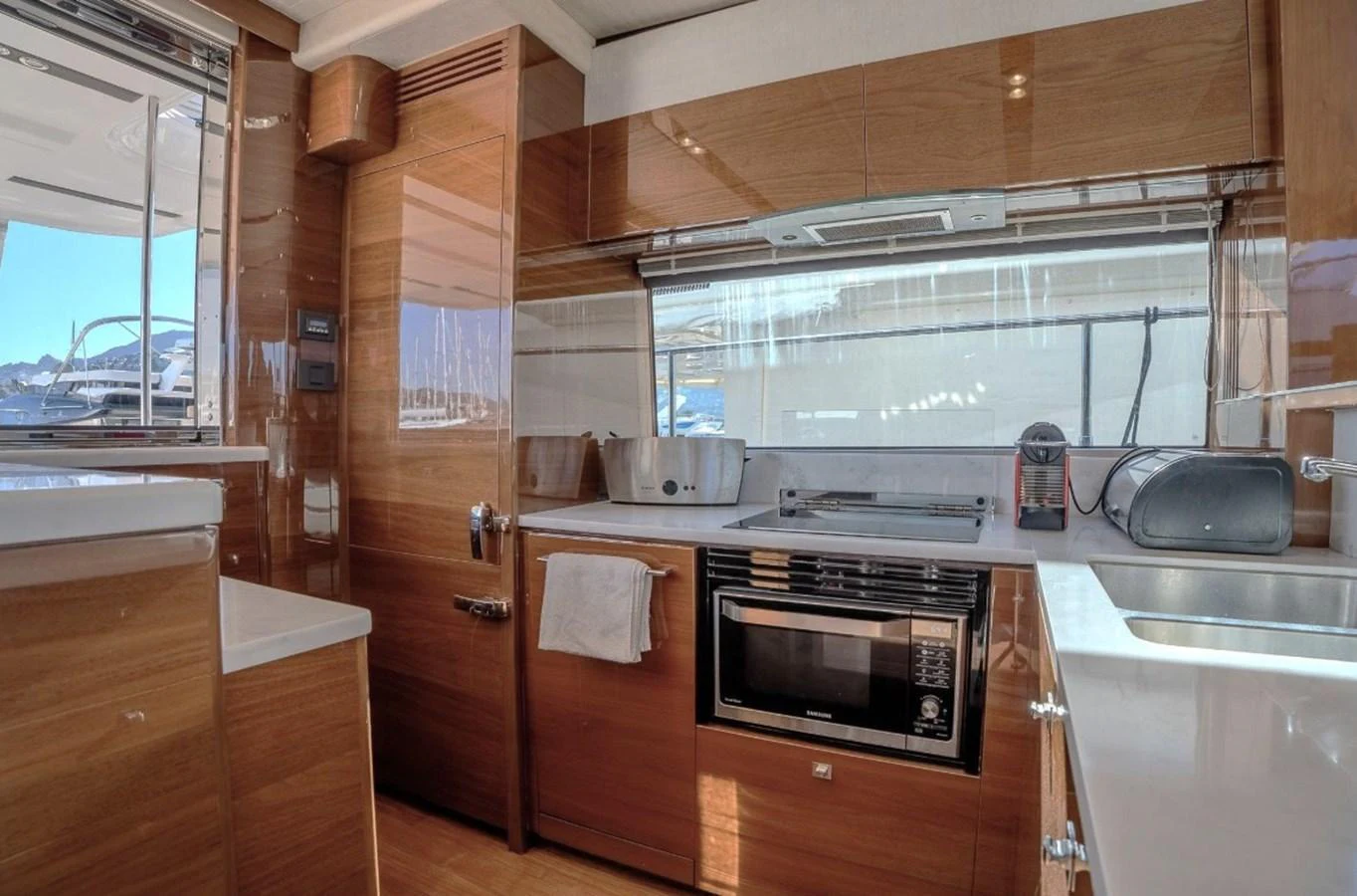 a kitchen with wooden cabinets aboard DANI Yacht for Sale