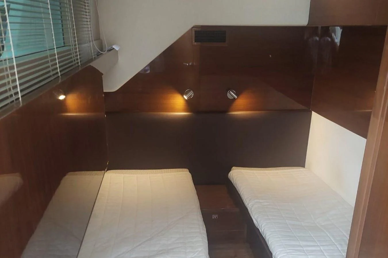 a room with beds and a window aboard DANI Yacht for Sale