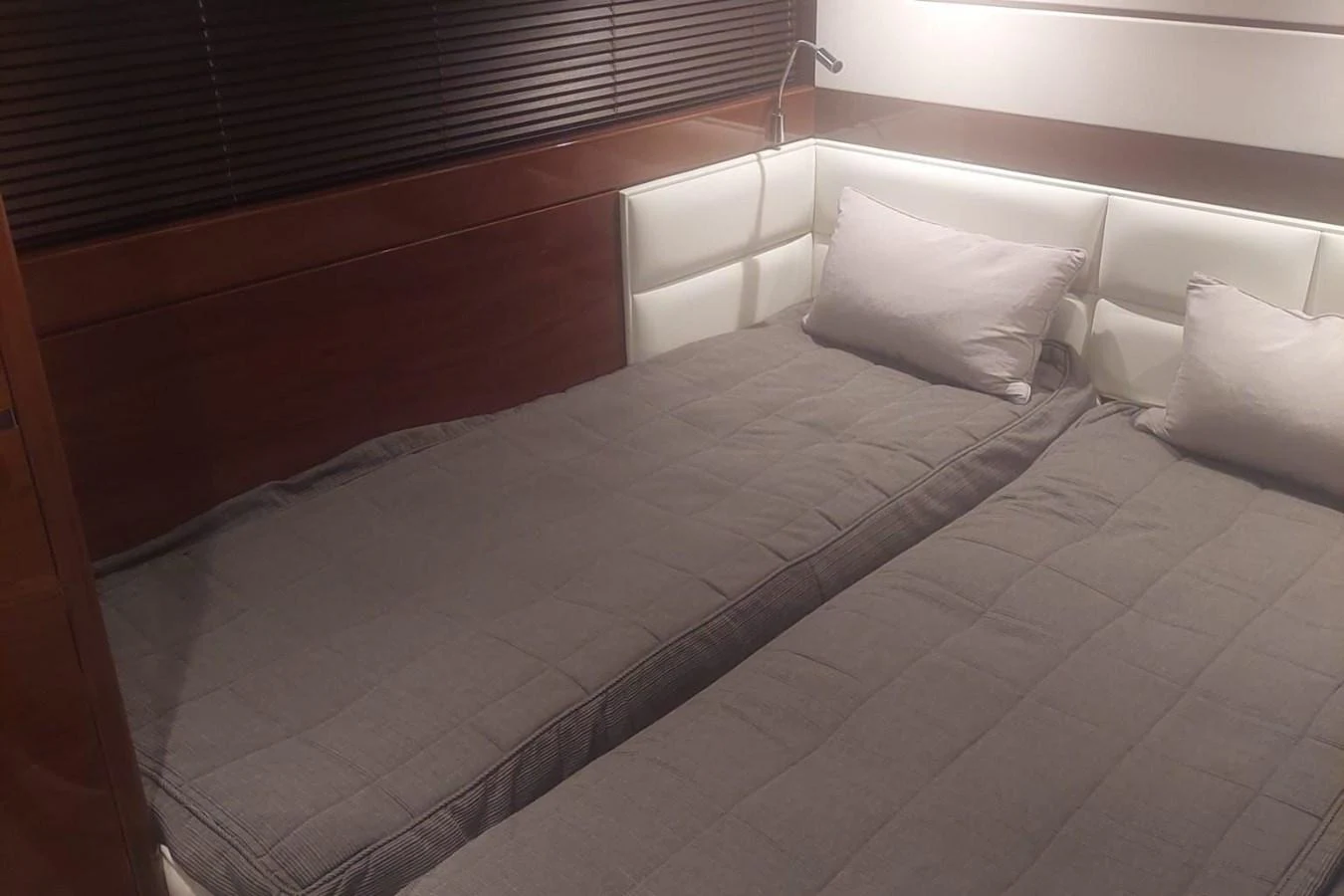 a bed with white sheets aboard DANI Yacht for Sale