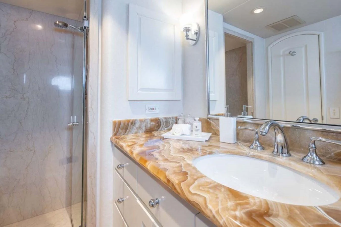 a bathroom with a countertop sink and mirror aboard CHANSON Yacht for Sale