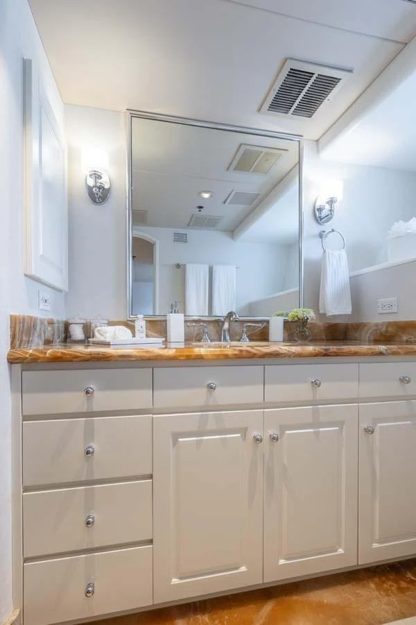 a kitchen with white cabinets aboard CHANSON Yacht for Sale