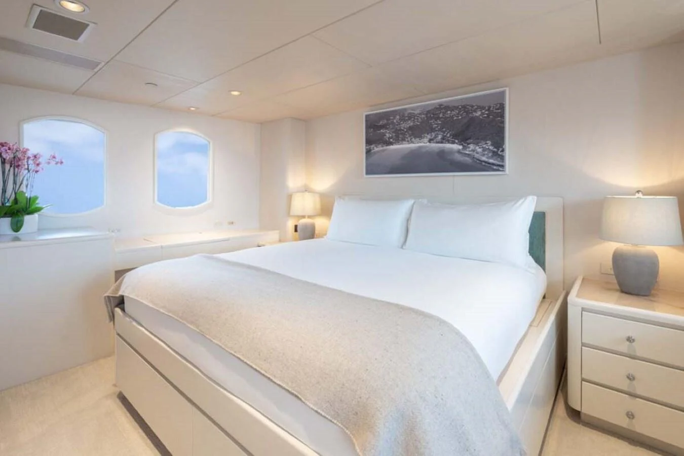 a bed with white sheets and pillows aboard CHANSON Yacht for Sale