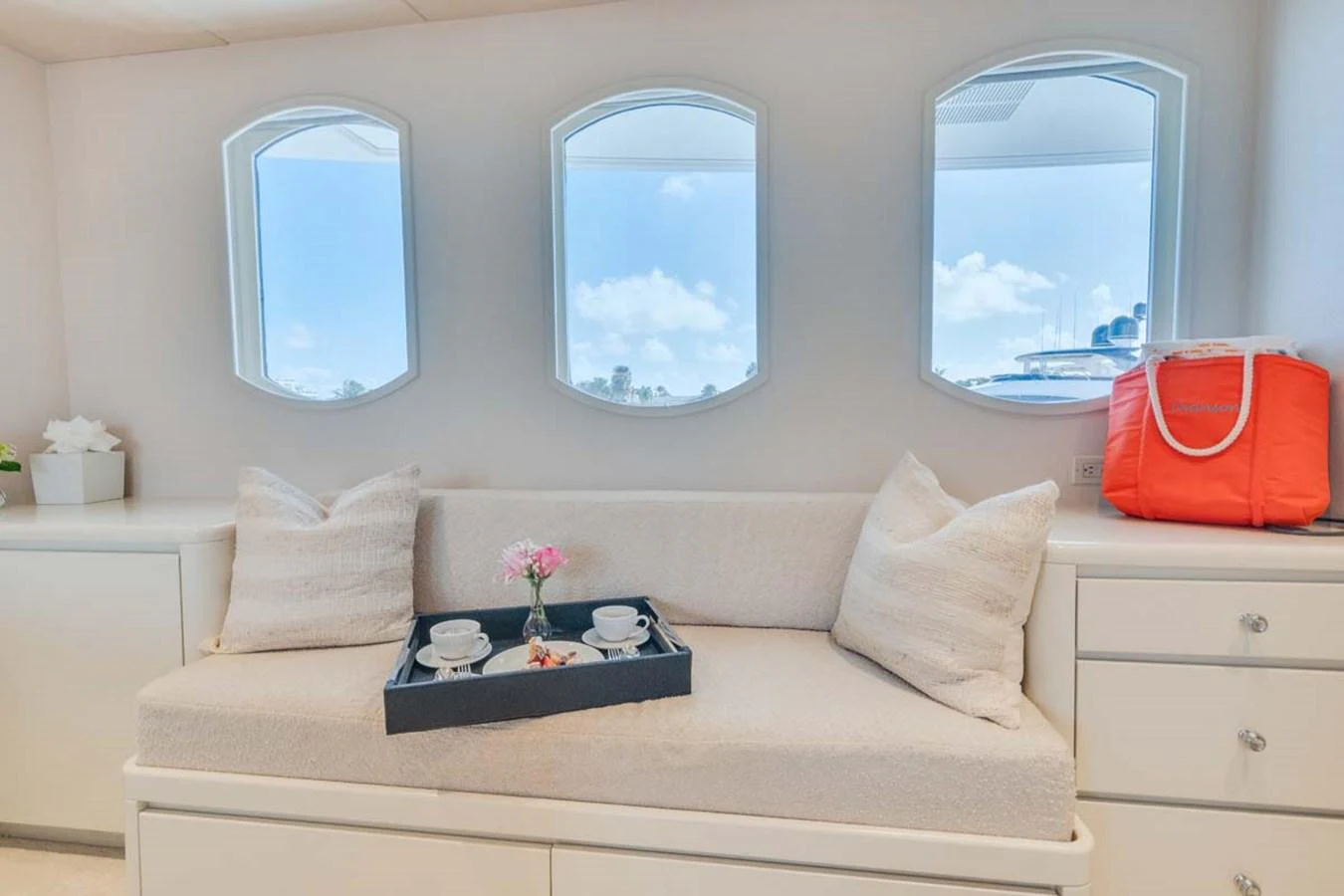 a white couch with a mirror above it aboard CHANSON Yacht for Sale