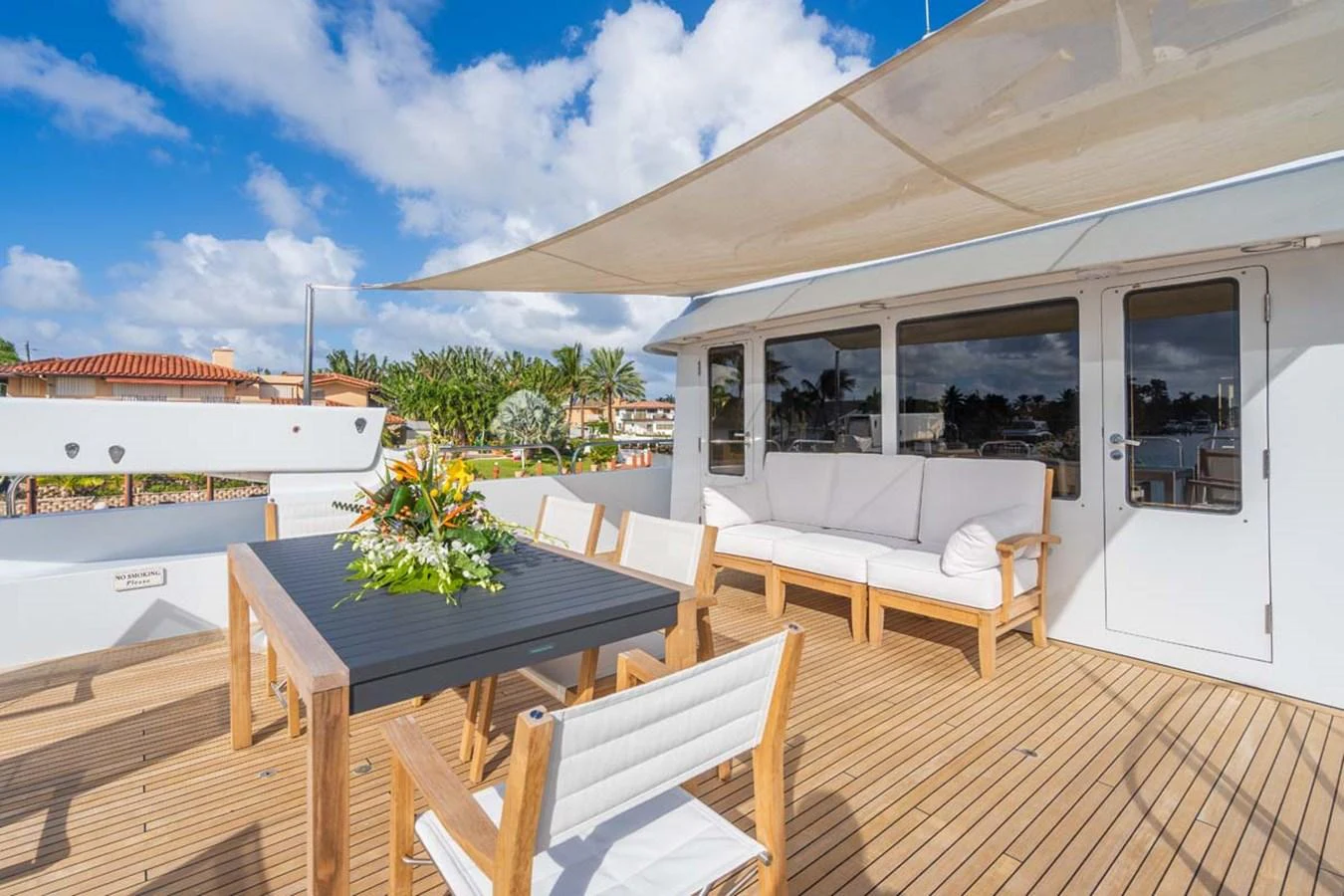 a deck with a table and chairs aboard CHANSON Yacht for Sale