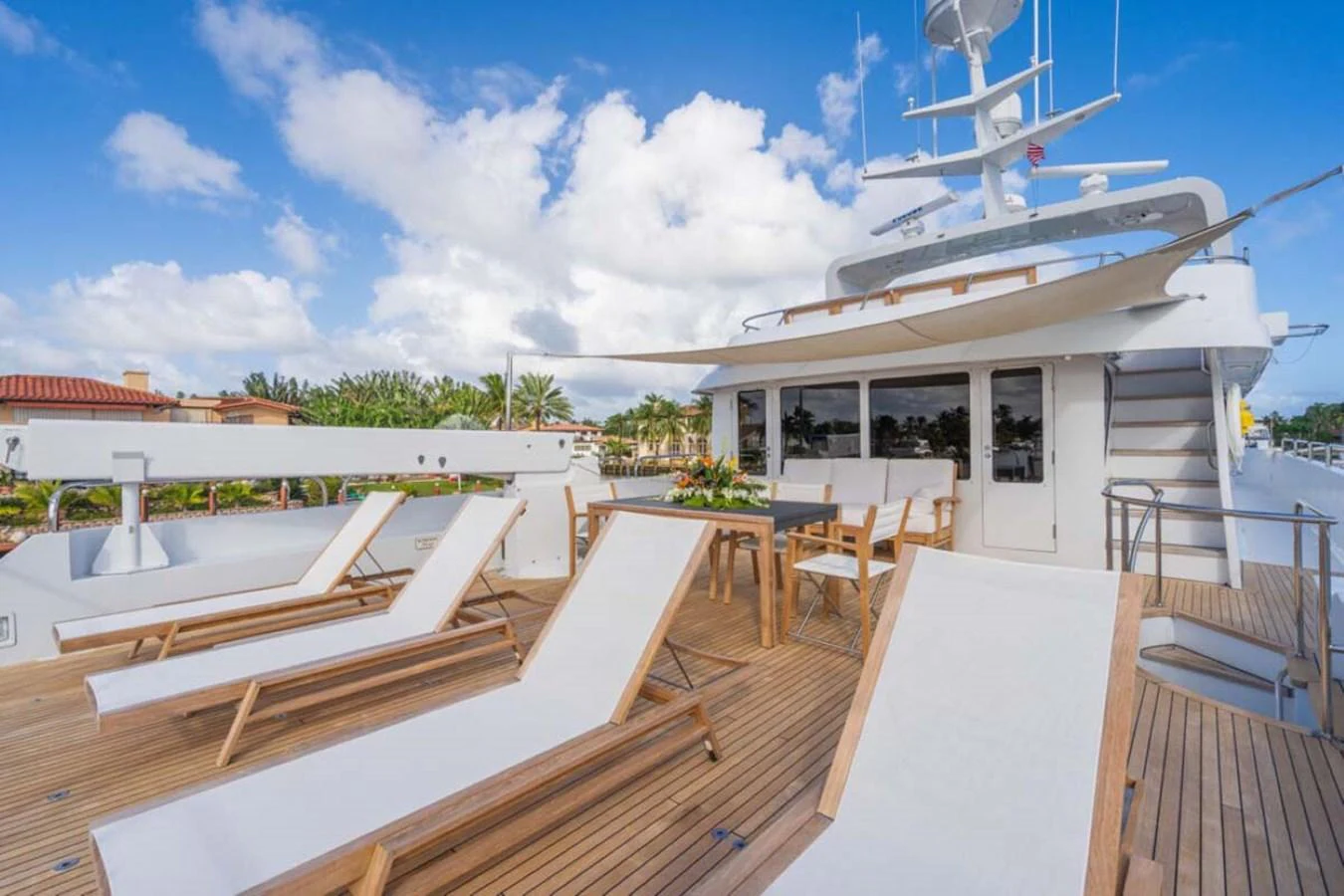 a deck with tables and chairs aboard CHANSON Yacht for Sale