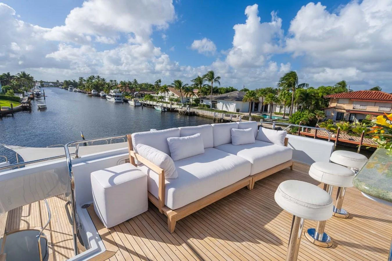 a white couch on a deck overlooking a body of water aboard CHANSON Yacht for Sale