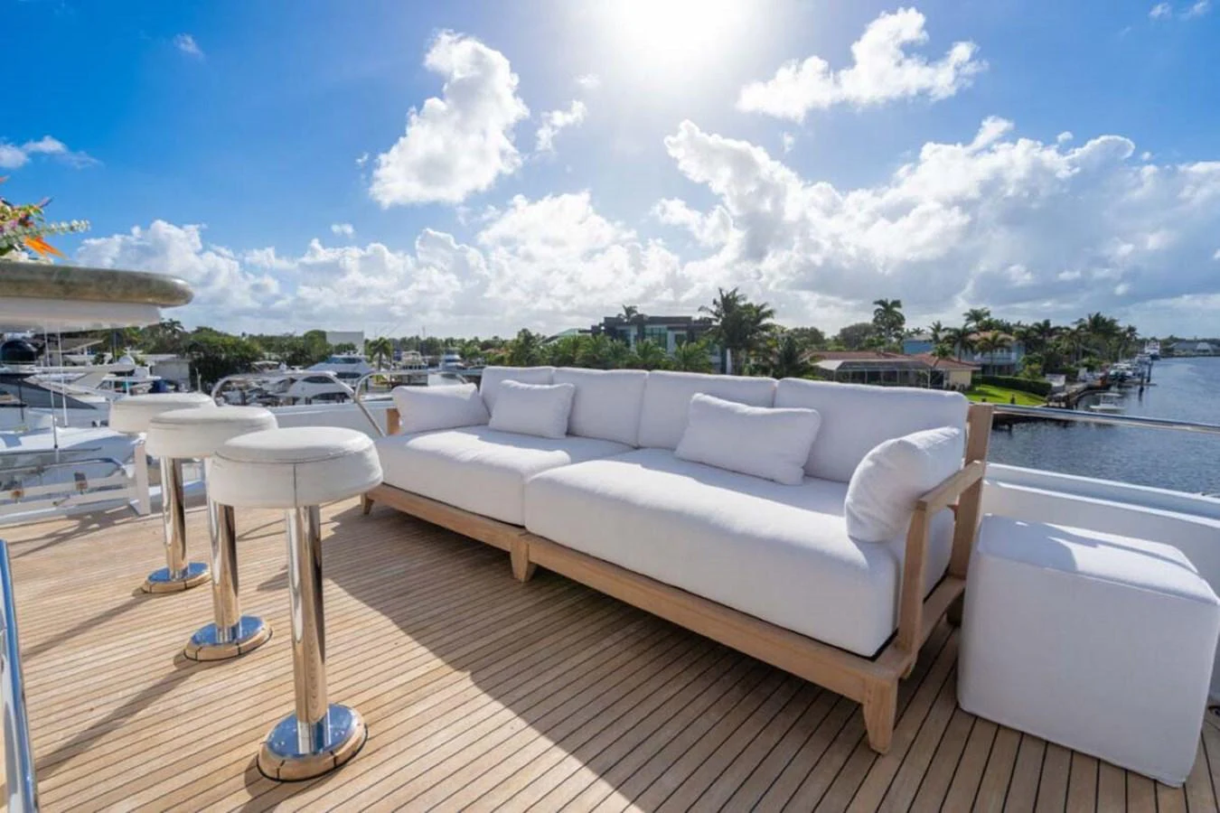 a white couch on a deck overlooking a body of water aboard CHANSON Yacht for Sale