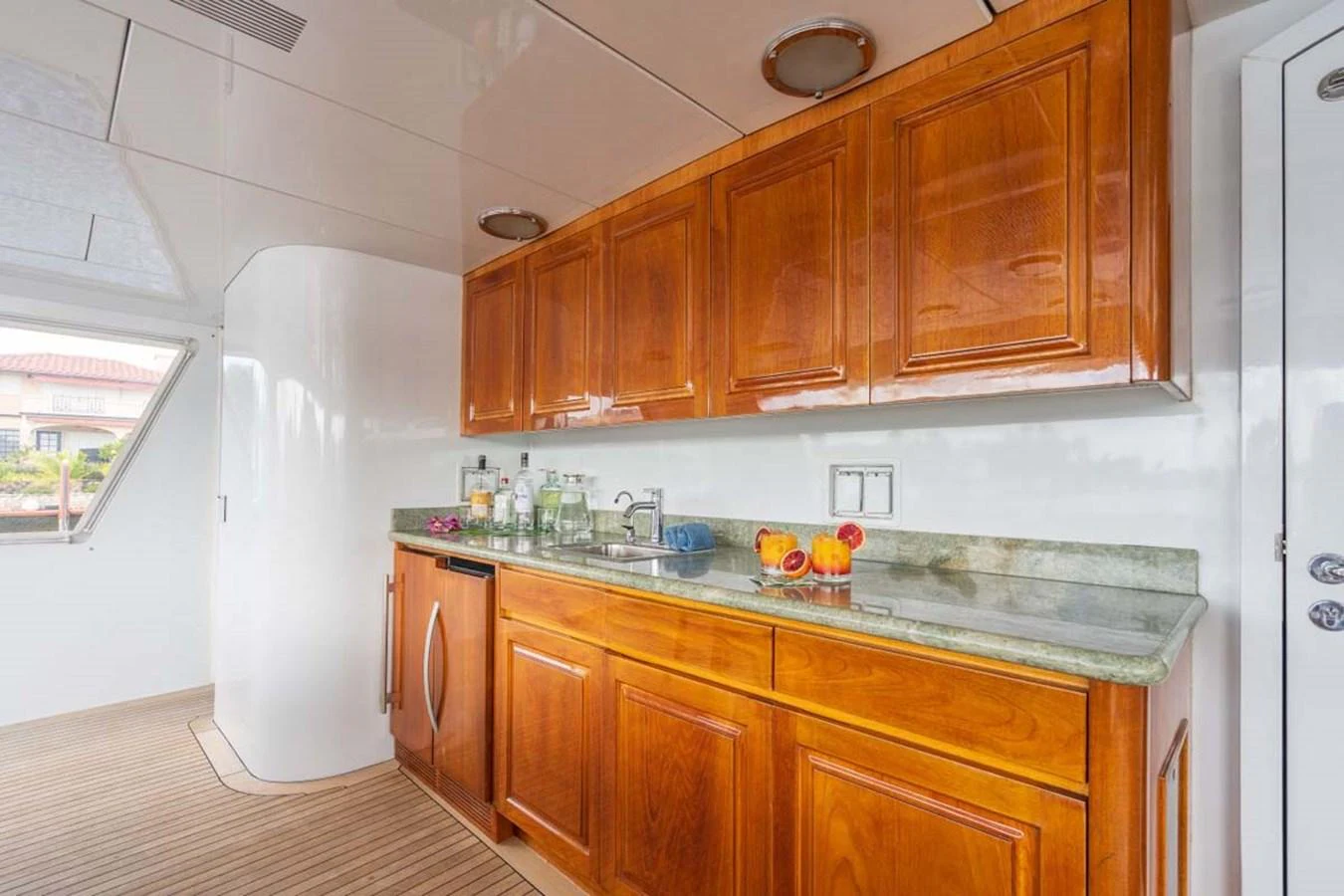 a kitchen with wooden cabinets aboard CHANSON Yacht for Sale
