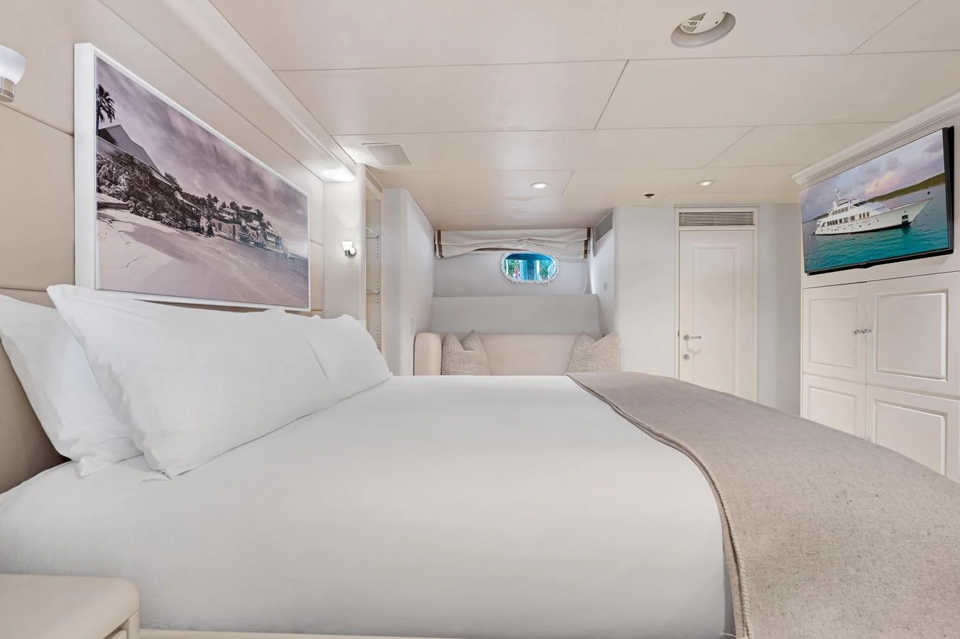 a room with a bed and a television on the wall aboard CHANSON Yacht for Sale