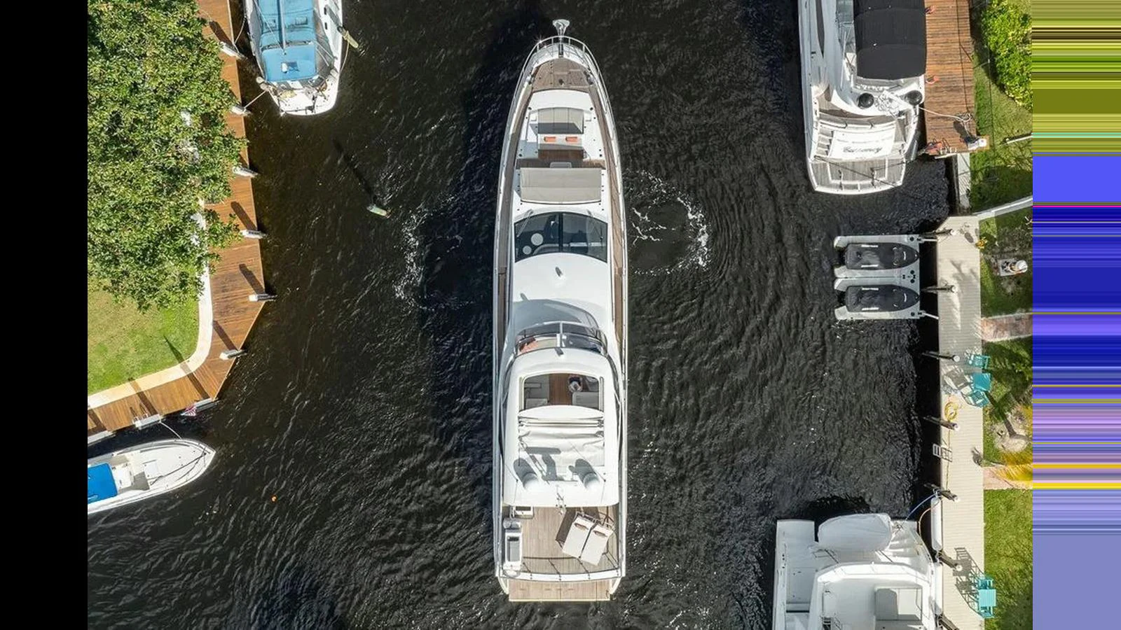 An aerial view of a yacht docked in a marina, showcasing its sleek design and spacious deck areas. aboard 2022 AZIMUT GRANDE 25 METRI Yacht for Sale