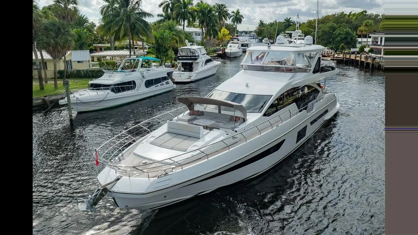 A sleek and modern yacht cruises through a serene waterway, surrounded by lush greenery and other boats. aboard 2022 AZIMUT GRANDE 25 METRI Yacht for Sale