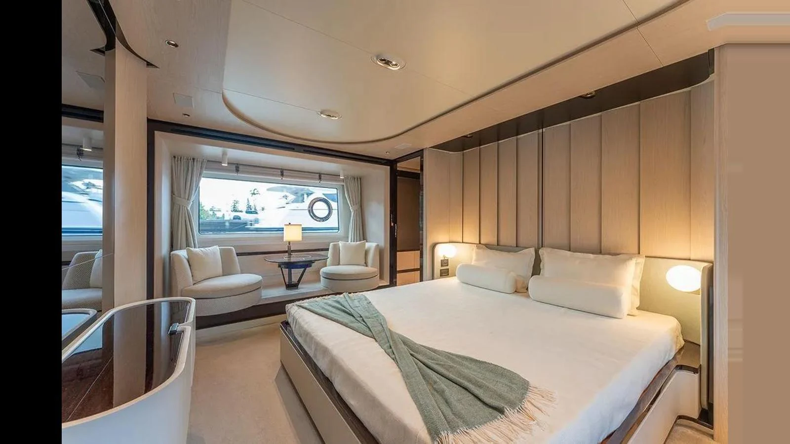 The master stateroom features a spacious bed and elegant seating area with a view of the water. aboard 2022 AZIMUT GRANDE 25 METRI Yacht for Sale
