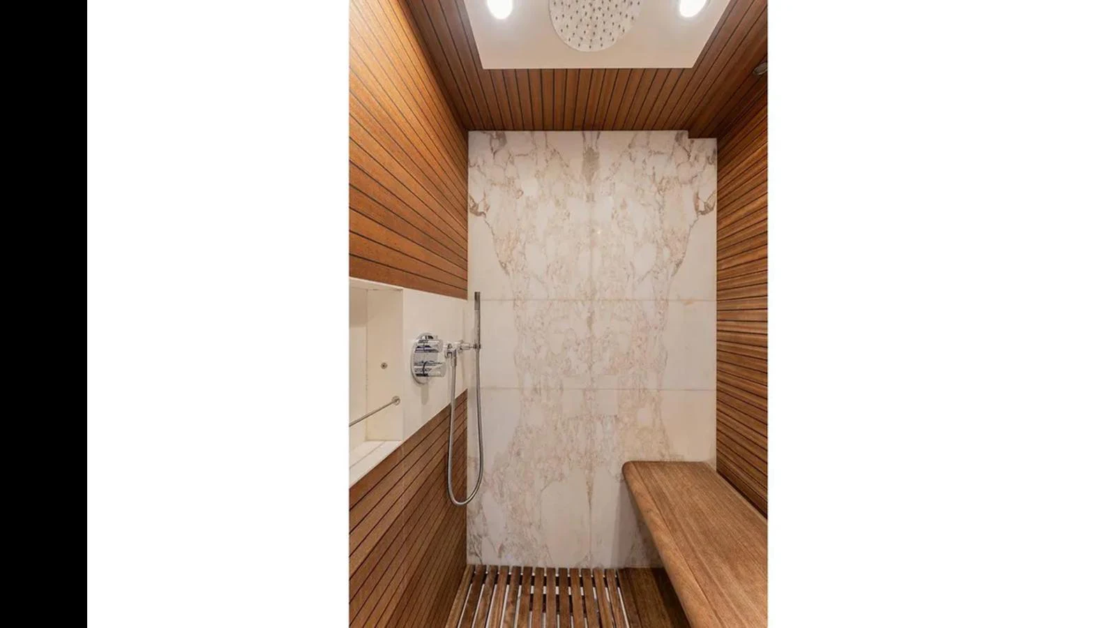 The yacht's bathroom features elegant wood paneling and a luxurious marble shower. aboard 2022 AZIMUT GRANDE 25 METRI Yacht for Sale