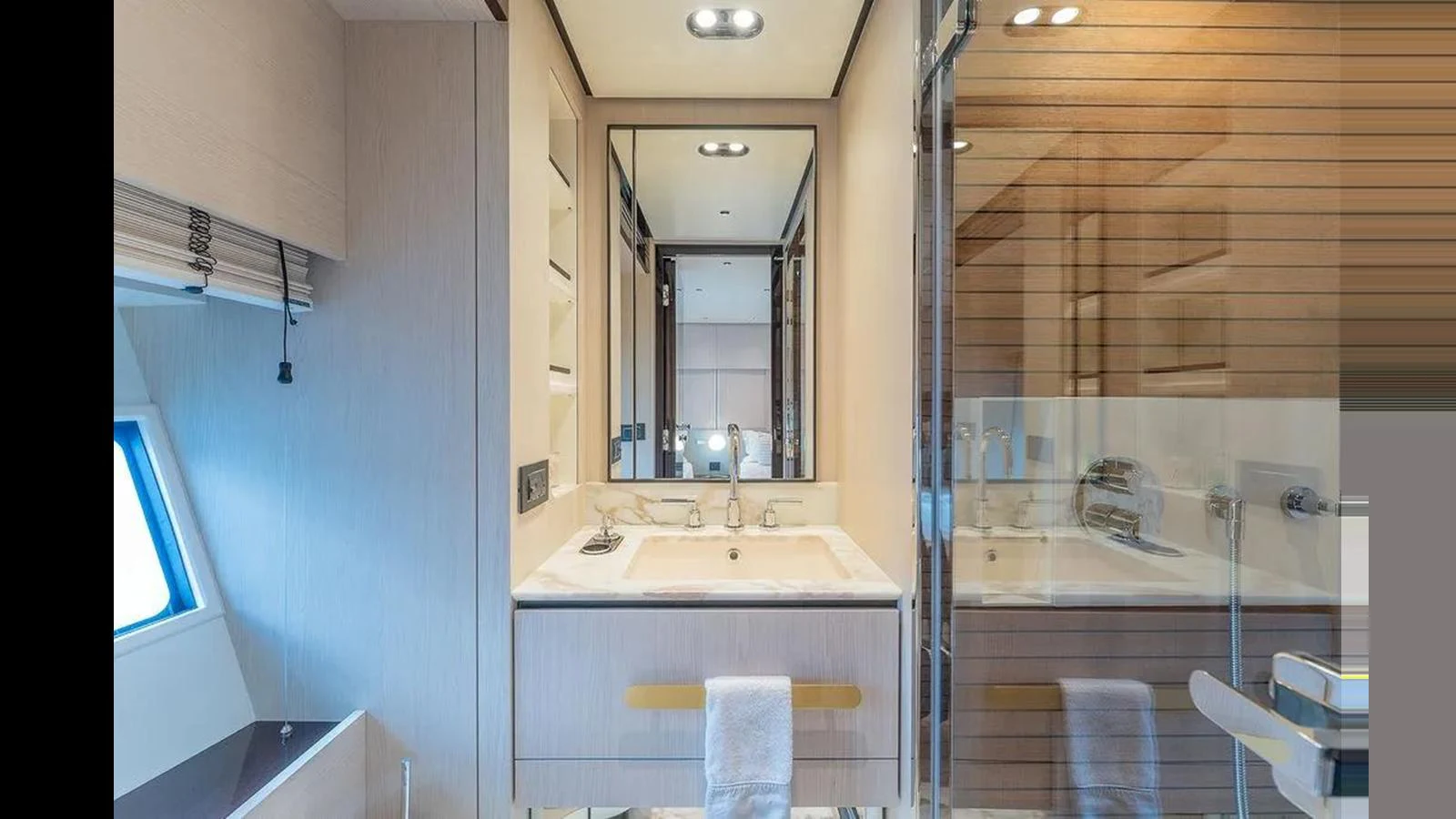 A modern yacht bathroom featuring a sleek vanity and a glass-enclosed shower. aboard 2022 AZIMUT GRANDE 25 METRI Yacht for Sale