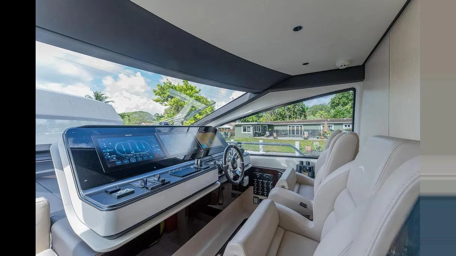 The helm station features modern controls and comfortable seating with a panoramic view. aboard 2022 AZIMUT GRANDE 25 METRI Yacht for Sale