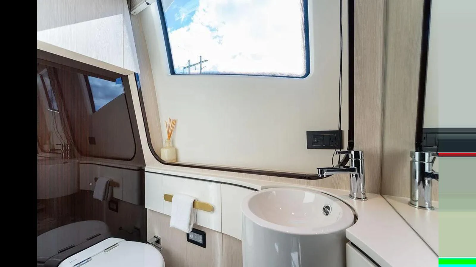 A modern yacht bathroom with sleek fixtures and a large window providing natural light. aboard 2022 AZIMUT GRANDE 25 METRI Yacht for Sale